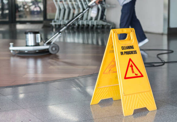 Woman worker cleaning the floor with polishing machine