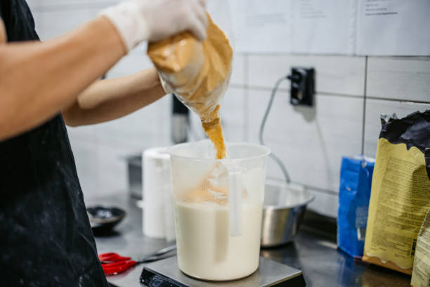 Young man preparing ice cream batter in an ice cream shop. Close-up.