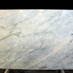 A large slab of natural stone of a gray-pink color is called Grey Portugalo.