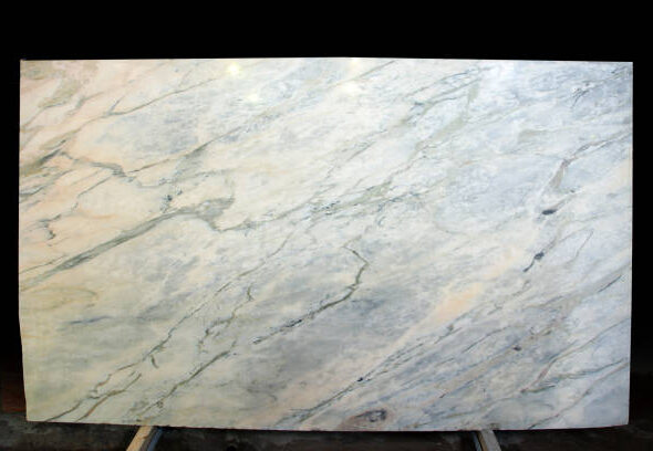 A large slab of natural stone of a gray-pink color is called Grey Portugalo.