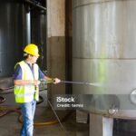 man washing around the industrial site