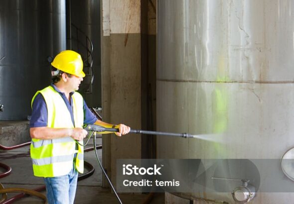 man washing around the industrial site