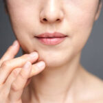 Middle-aged Japanese woman worried about wearing a cheek stick