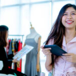 Portrait of beautiful young designer smiling in the store